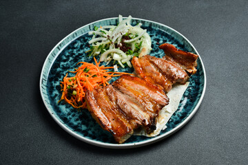 Grilled juicy pork ribs with onions and pita bread. Barbecue menu. Free space for text. Close up.