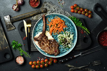 Wild boar steak on the bone. Meat barbecue menu. Free space for text. Close up.