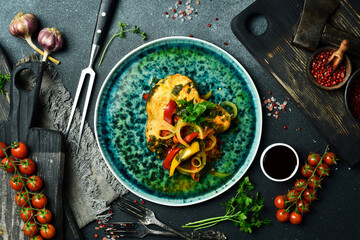 Stewed sturgeon steak with vegetables. Fish menu. Free space for text. Close up.