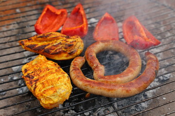 grilled vegetables, grilled chicken fillet and sausages, grilled vegetables, grilled red pepper. Roasted sausages on the campfire