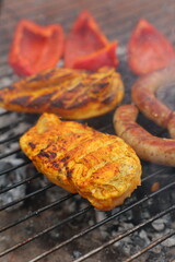 grilled vegetables, grilled chicken fillet and sausages, grilled vegetables, grilled red pepper. Roasted sausages on the campfire