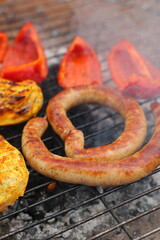 grilled vegetables, grilled chicken fillet and sausages, grilled vegetables, grilled red pepper. Roasted sausages on the campfire