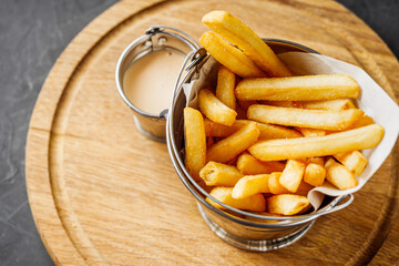 delicious hot crispy french fries on a rustic background