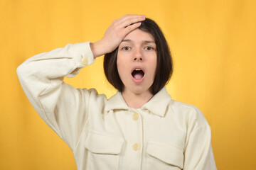 surprised young brunette woman looking at the camera