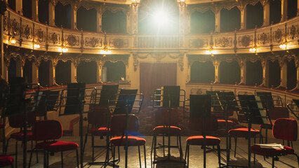 Wide shot of an Empty Elegant Classic Theatre with Big Stage and Orchestra Musicians' Chairs....