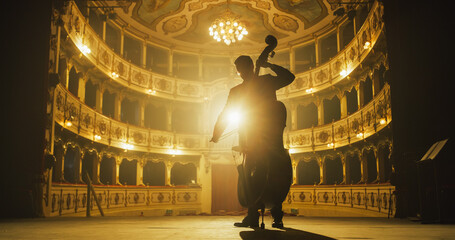 Cinematic shot of Male Cellist Playing Cello Solo on an Empty Classic Theatre Stage with Dramatic...