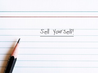 Pencil on lined notebook with text written SELL YOURSELF, concept self marketing in professional business world to get hiring or make money with or writing from customers