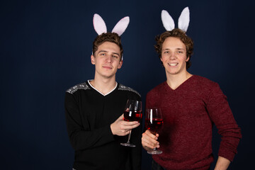 Easter. Two young attractive guys dressed as rabbits. Happy couple. 