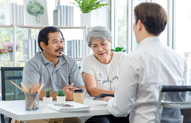 Fototapeta premium Asian old senior elderly female patient with male cousin sitting together in clinic office room listening to unrecognizable unknown doctor in white lab coat explaining about symptoms and heal therapy
