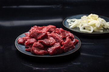 Pieces of tender beef in marinade for cooking.