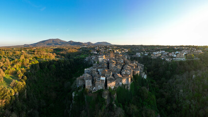Fototapeta premium View from above, stunning panoramic view of the village of Vitorchiano at sunset. Vitorchiano is a medieval Italian village in Viterbo Province, Lazio, Italy.