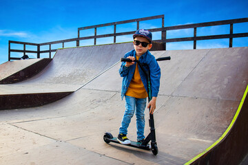 a boy on a scooter on a ramp