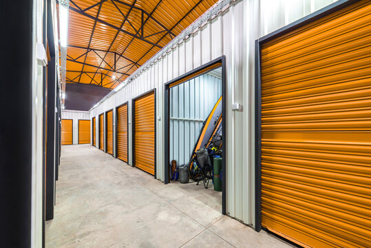 Corridor of self storage unit with red doors. Rental Storage Units