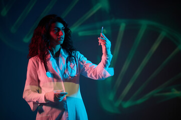 Dark-haired doctor witha syringe in hand