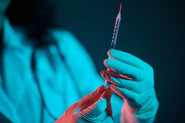 Dark-haired doctor witha syringe in hand