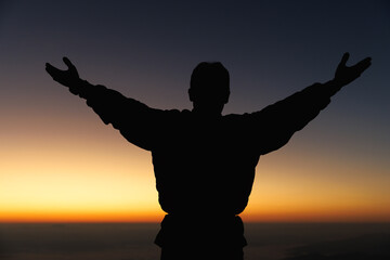 Silhouette of man hand praying spirituality and religion, female worship to god. Christianity...