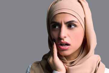 Fototapeta na wymiar Headshot of a young woman in beige hijab
