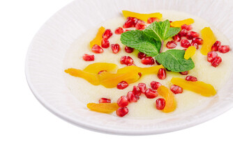 Plate of oatmeal with porridge , dried apricots and pomegranates