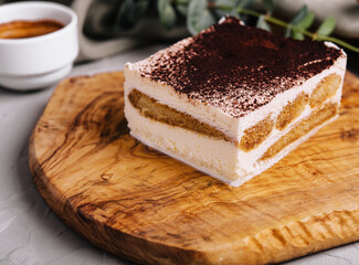 Traditional italian tiramisu dessert with cup of coffee