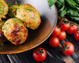 Fried meatballs decorated with salad and tomatoes