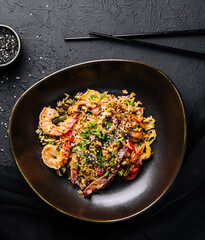 Top view of fried rice with seafood and vegetables prepared in Chinese wok