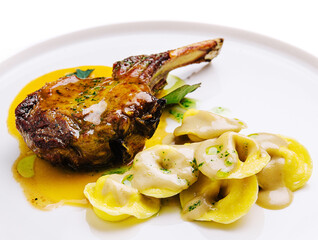 tomahawk steak and ravioli on plate