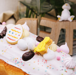 Easter cake with meringue decorated with chocolate bunny and eggs