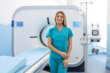 Beautiful happy female doctor physician radiologist standing in CT CAT Scan room at hospital.