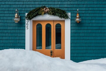 Beautiful house entrance with Christmas decorations blocked by snow