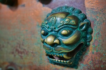 Closeup shot of a shiny traditional Chinese dragon mask, on an old stone wall