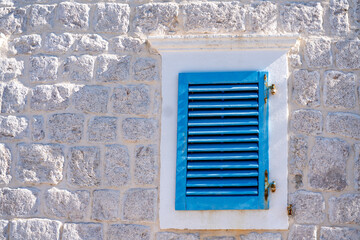 Old stone house with blue shutters., mediterranean building facade