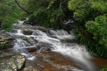 Long exposure river flowing over a rocky surface in a forest