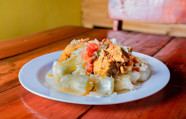 Traditional Chancho dish with Yuca. Nicaraguan pork with yucca served on wooden table