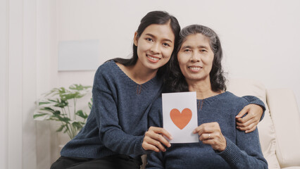 Greeting card, Mother's day concept, young adult female daughter congratulate excited asian elderly...