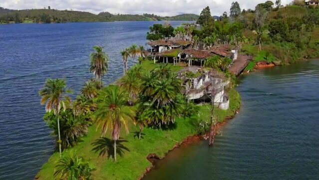 Drone shot of La Manuela Hacienda ruins and seascape in Guatape, Colombia