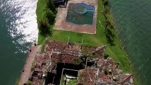 Drone shot of La Manuela Hacienda ruins and seascape in Guatape, Colombia