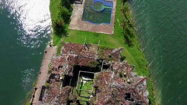 Drone shot of La Manuela Hacienda ruins and seascape in Guatape, Colombia