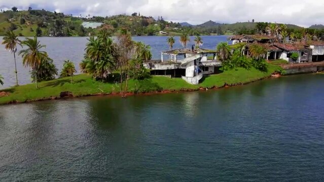 Aerial video of La Manuela Hacienda Ruins on the island surrounded by water, Guatape, Colombia