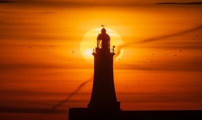Drone closeup of the silhouette on the North Pier Lighthouse at sunrise in Michigan, USA