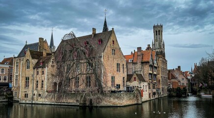 Fototapeta premium Canal surrounded by buildings in Bruges
