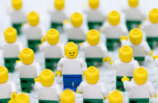 Hong Kong -April 11 2023: a man dress in different pant, inside the  crowd of bald people and become outstanding