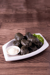 vegan deep fried crispy black charcoal beancurd tofu with salad tartar creamy white sauce vegetable on wood table asian chinese appetiser snack banquet halal food menu for restaurant gourmet buffet, 