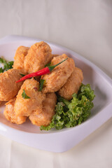 vegan deep fried golden beancurd tofu in salted egg yolk curry leaf pumpkin cream chilli vegetable on wood table asian chinese appetiser snack banquet halal food menu for restaurant