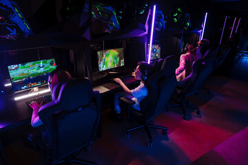Team of gamers playing online game on championship in cybersport club © Drobot Dean