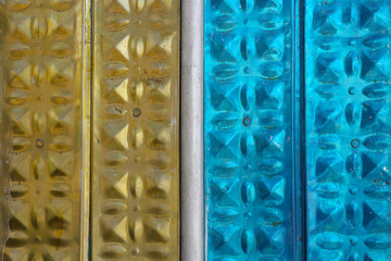 Metallic background in yellow and blue with patterned embossing.