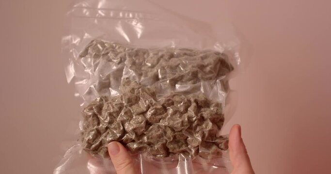 Packing cannabis for transportation in a bag. Sealed bag to protect against odor and drying out. Demonstration of HHC raw material.