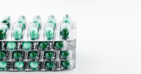 Green pills in plastic package. Global healthcare concept.