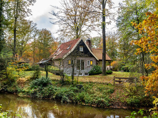 Fototapeta na wymiar House and Dinkel river in autumn between Losser and Denekamp, Twente, Overijssel, Netherlands