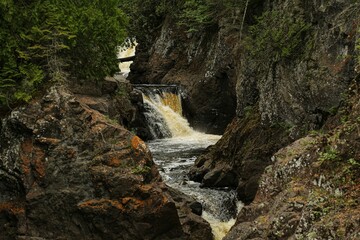 Landscape of a beautiful waterfall surrounded by rocks in a forest