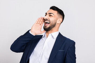 Naklejka premium Angry man shouting out screaming in a loud voice furious sussessful guy in ellegant suit.